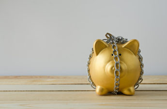 Gold piggy bank in chains