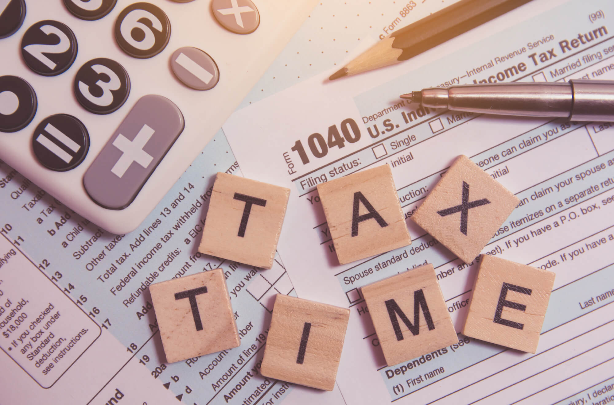 Tax time with wooden alphabet blocks on a 1040 form