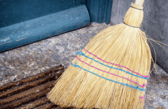 Old straw broom on a porch