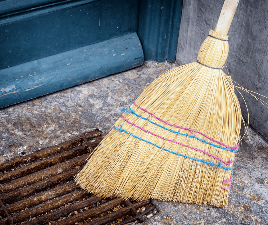 Old straw broom on a porch