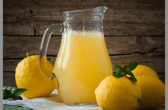 pitcher of homemade lemonade and lemons