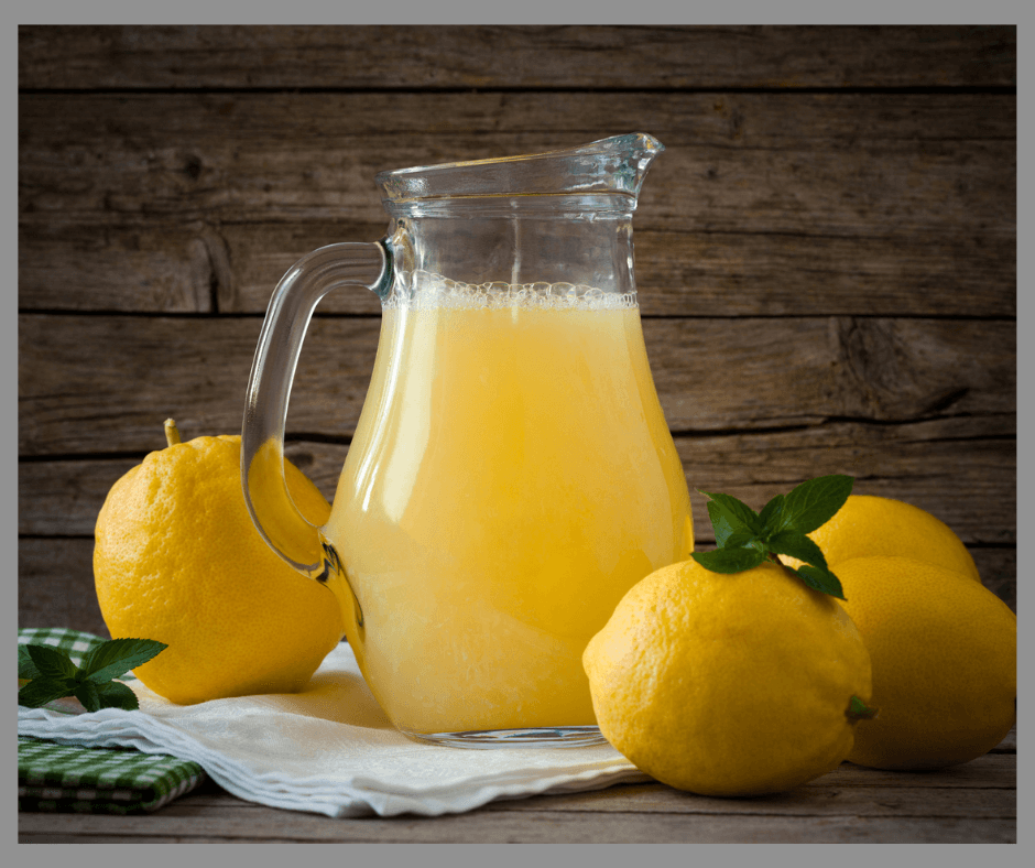 pitcher of homemade lemonade and lemons