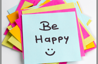 Happy written on a pile of sticky notes with a smiley face.