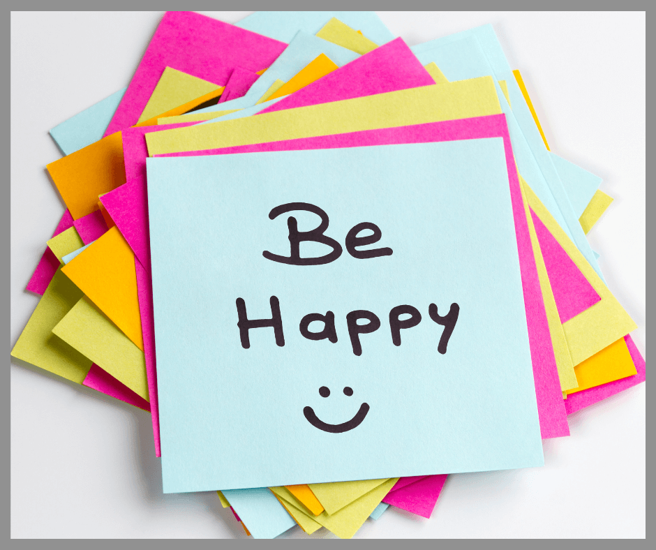 Happy written on a pile of sticky notes with a smiley face.