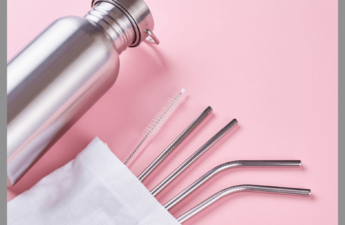 Reusable straws in a pouch with a bottle on a pink background