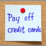 A Post-it with a reminder to pay off credit cards