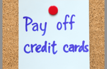 A Post-it with a reminder to pay off credit cards