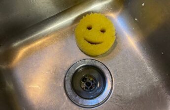A Yellow Scrub Daddy in a sink