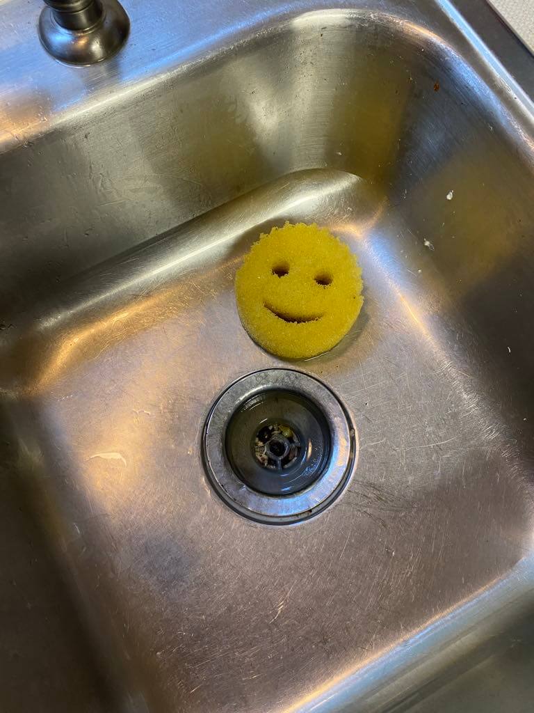 A Yellow Scrub Daddy in a sink