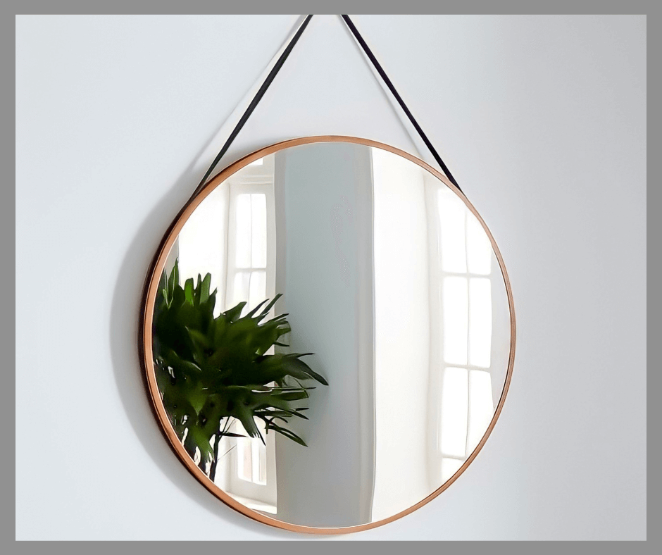 Wall mirror reflecting a part of a plant