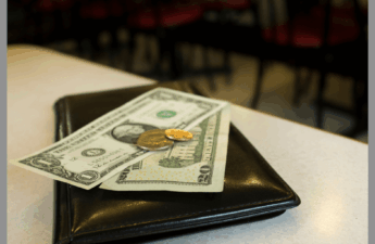 Dollar bills on top of a restaurant folder