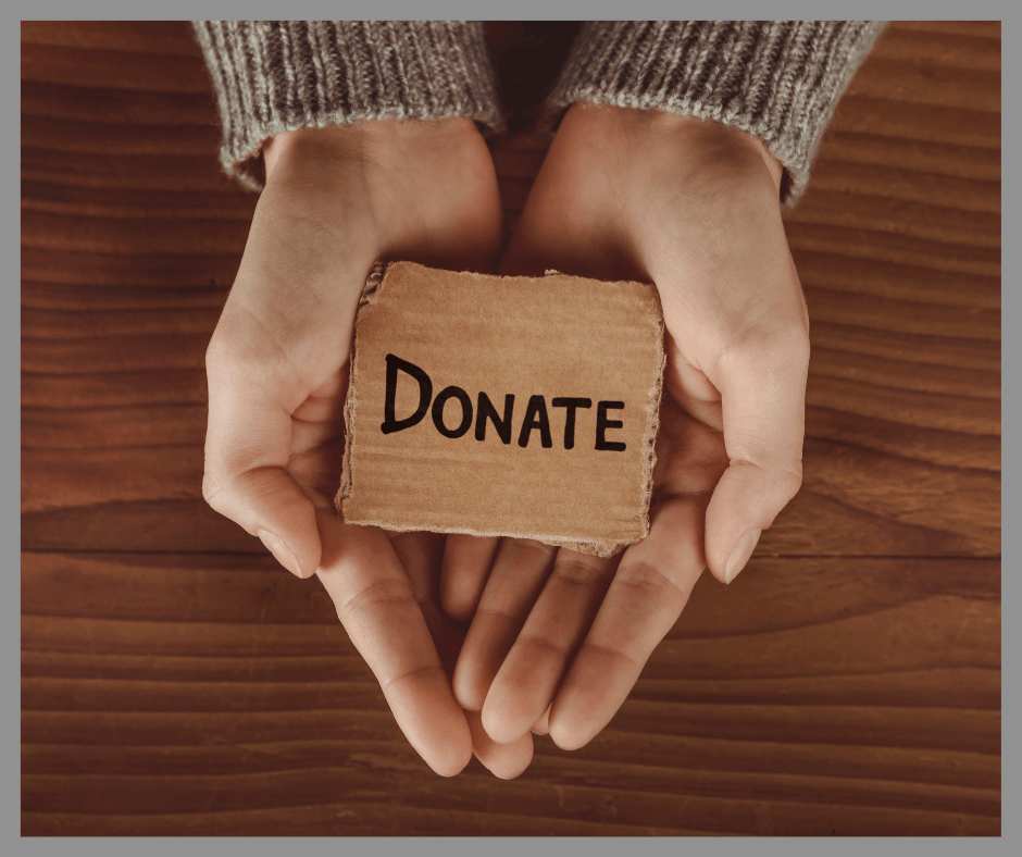 Two hands holding a donate sign