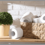 Toilet paper organized in a pretty wicker basket