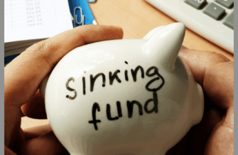 White Piggy Bank with Sinking Fund written on it.
