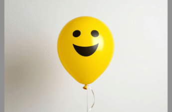 A yellow balloon with a happy face on it.