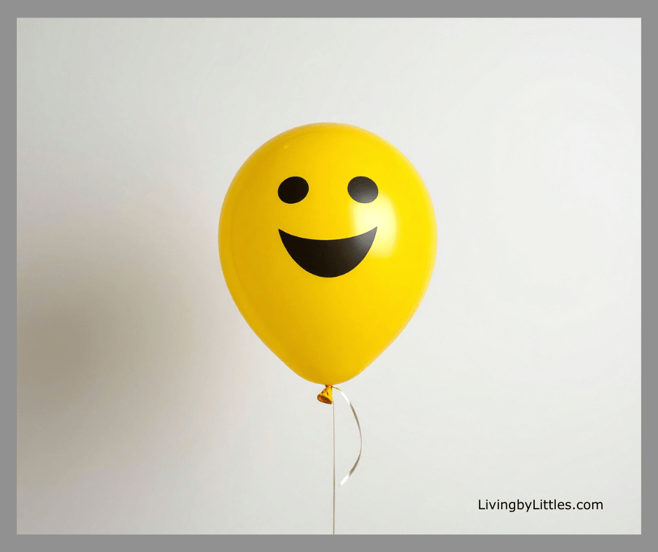 A yellow balloon with a happy face on it.